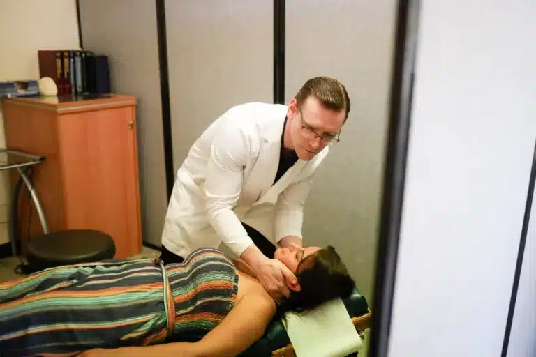Dr. Michael Brandon, D.C., treating a patient's neck in the Colts Neck treatment room