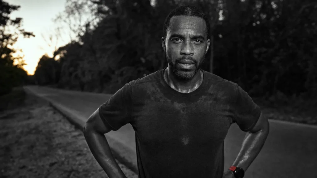 A man in his forties pauses on a country road at dusk after a run. (AI-generated image)